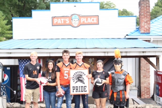 people wearing jerseys and holding sign